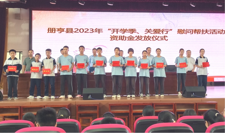 圖為在冊亨縣第三中學發放資助金。