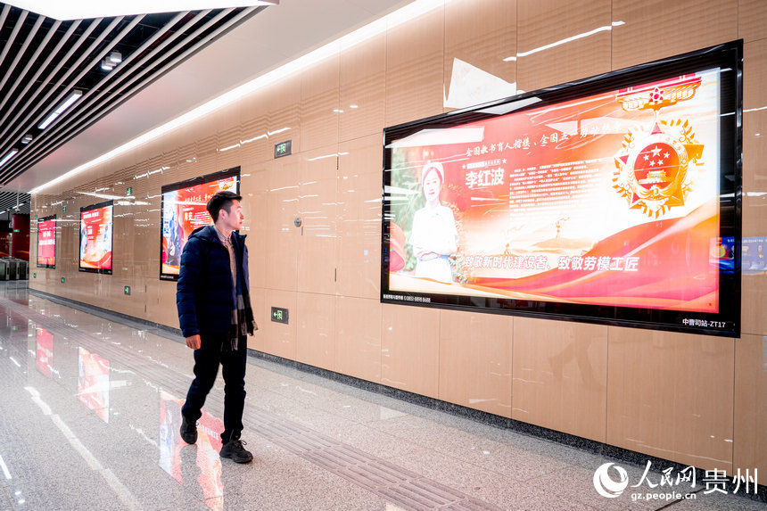 市民駐足觀看勞模工匠的展示板。人民網 陽茜攝