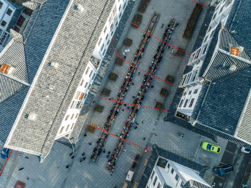 活動現場，社區群眾在共享長桌團圓飯。羅大富攝