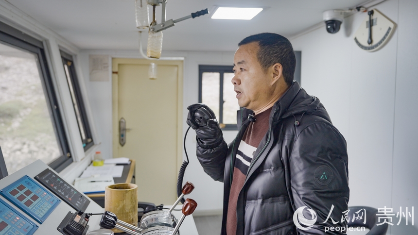 船長田永成與烏江上的其他船只溝通。人民網記者 涂敏攝