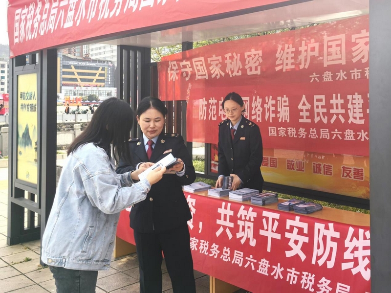 稅務人員為群眾發放并解讀宣傳手冊。梁敏攝