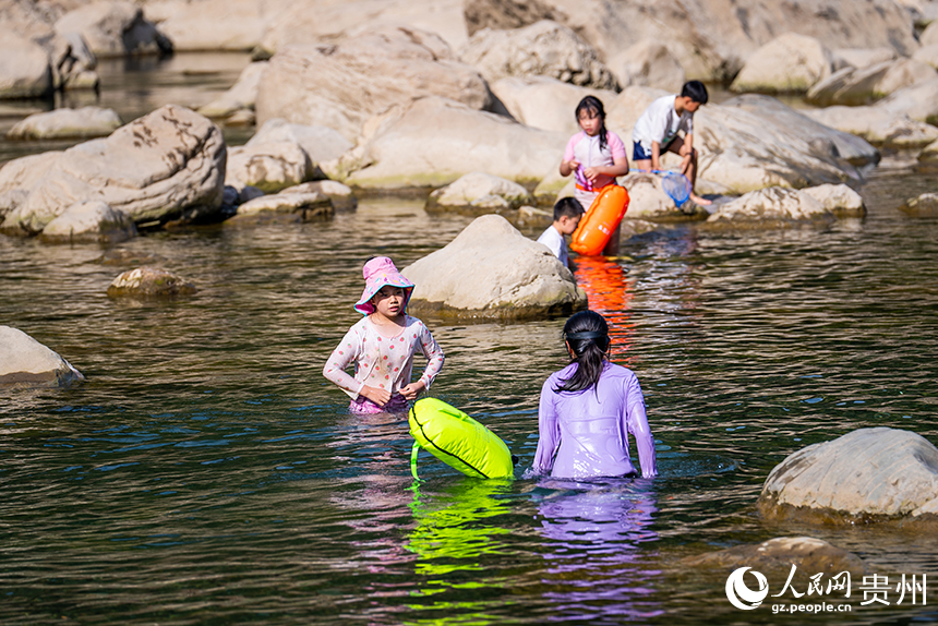 游客在淺灘處戲水嬉戲。人民網記者 涂敏攝