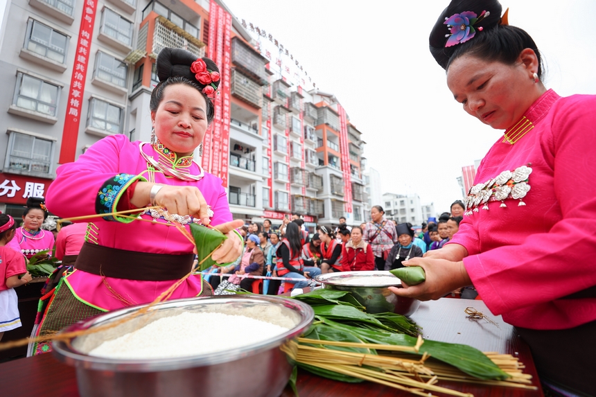 2025年5月29日，在貴州省丹寨縣金泉街道，身著傳統服飾的搬遷群眾在參加包粽子比賽。 