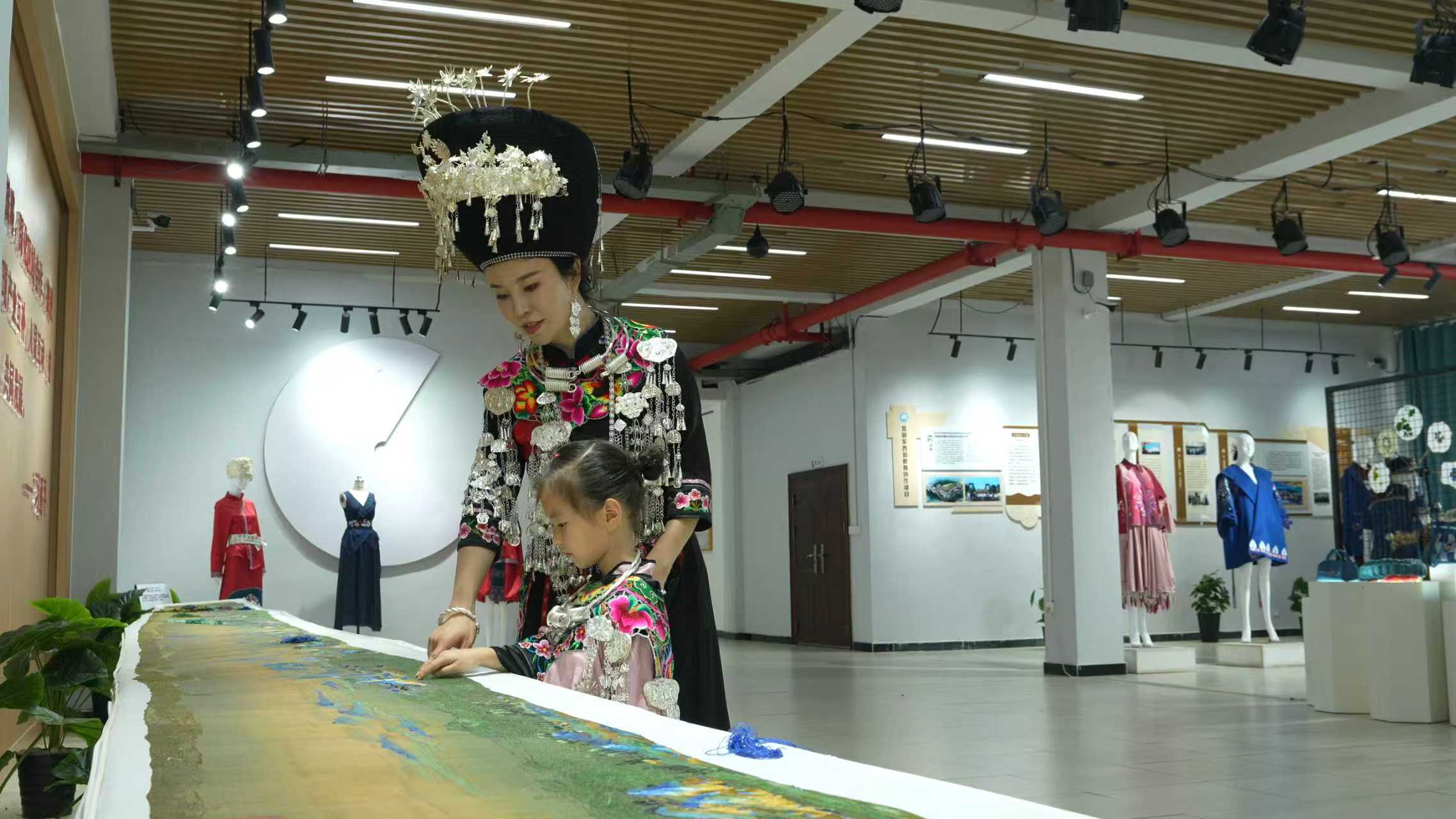 貴州省松桃縣“愛心媽媽”講解非遺苗繡.