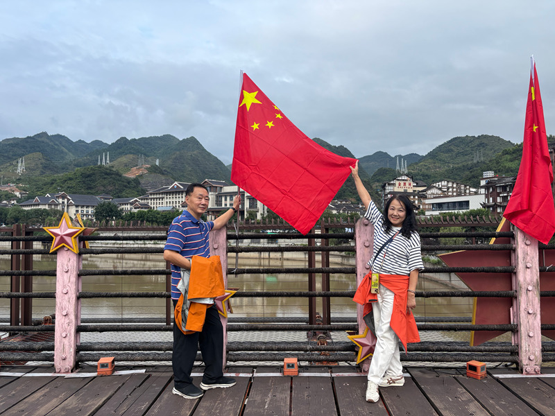 游客在紅軍橋上拍照打卡。